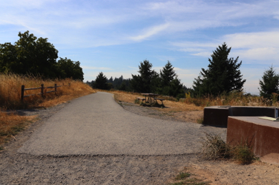 Summit Lane natural surface gravel trail transitions to paved Mountain View Trail at Mountain Finder – picnic bench